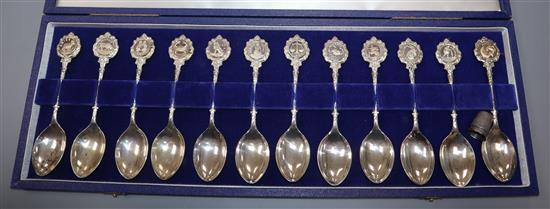 A set of twelve David Cornell silver Zodiac spoons, cased, retailed by John Pinches, in fitted case, and a thimble